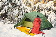 © Bondariev Volodymyr. - Walk through the winter forest with a backpack and tent.