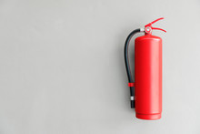 Fire Extinguisher On The Gray Wall