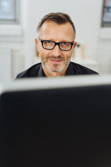 Wall Mural - Businessman wearing glasses smiling at camera