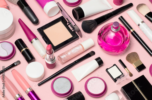 Fotografering Set of makeup cosmetics, brushes, concealer and other essentials on pink backgro