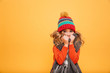 © Drobot Dean - Young girl in sweater, scarf and hat having cold