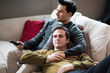 © ReeldealHD images - Young male couple relaxing on sofa