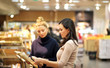 © lado2016 - Women choosing bread  from a supermarket,selective focus
