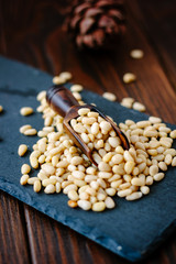 Sticker - Pine nuts on a black slate with wooden scoop