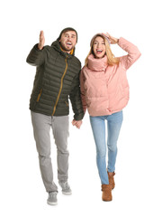 Poster - Young couple in casual clothes walking on white background