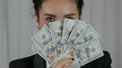 Happy Business Woman Displaying a Spread of Cash. Successfuly girl wins bucks in lottery. Concept of money health, abundance, new idea, successful. Close-up