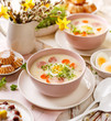 White borscht, polish Easter soup with the addition of white sausage and a hard boiled egg in a ceramic bowl. Traditional Easter dish in Poland