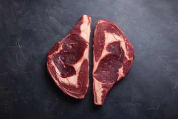 Canvas Print - Raw fresh marbled meat Steak Ribeye Black Angus on black marble background. Beef with spices on a dark stone table. Top view