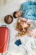 © LIGHTFIELD STUDIOS - overhead view of couple of tourists lying on bed in hotel room