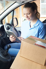 Wall Mural - Female Courier In Van With Digital Tablet Delivering Package To House