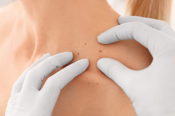 Wall Mural - Oncologist examining female patient, closeup. Cancer awareness