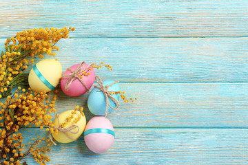 Canvas Print - Easter eggs with mimosa flowers on wooden background