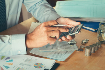 Fototapete - accountant using calculator calculate budget for saving. concept finance and accounting