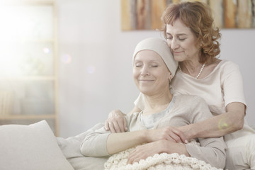 Wall Mural - Mother hugging happy sick woman