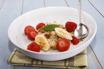 Wall Mural - healthy breakfast with oatmeal, walnut, strawberry and mint leaf