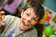 © Мар'ян Філь - The young boy with a painted face roars like a lion and is preparing to attack