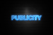 Publicity neon Sign on brickwall