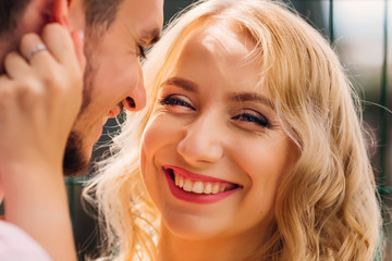 Wall Mural - a woman with a pretty face smiles genuinely in the camera lens and the guy next to her