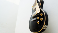 Black Guitar Model Les Paul On A White Background Showing Part Of The Body In A Bottom View