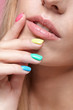 © Serg Zastavkin - Young blonde woman with fun  varicoloured finger nails manicure.
