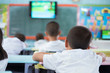 © narongchaihlaw - Group student learning by television in class at the elementary school. Education concept.