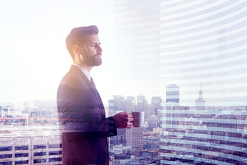 Wall Mural - Man drinking coffee in city