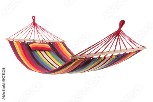 Photographie a multi-colored hammock made from natural fabric hanging on ropes, white backgro