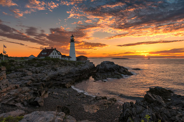 Wall Mural - Sunset at Portland Head Lighthouse in Cape Elizabeth, Maine, USA.  One Of The Most Iconic And Beautiful Lighthouses.