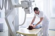 © Science RF - Doctor adjusting patient's neck before an x-ray