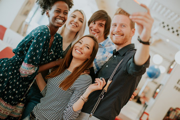 Wall Mural - Group of young people taking selfie with mobile phone