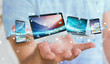 © sdecoret - Businessman connecting tech devices and icons applications 3D rendering