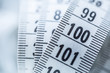 © weyo - Curved measuring tape. Measuring tape of the tailor. Closeup view of white measuring tape