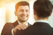 © realstock1 - The happy businessmen hold on the shoulder in the office