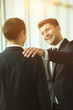 © realstock1 - The happy businessmen pat on the shoulder