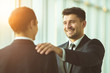 © realstock1 - The happy businessmen hold on the shoulder in the office