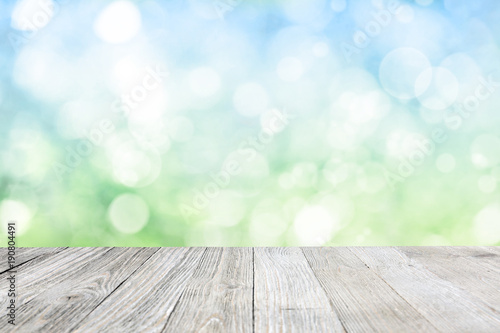 Wooden deck with blurred meadow background