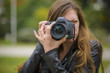 © Teodor Lazarev - Young professional or amateur photographer taking a picture with her dslr camera