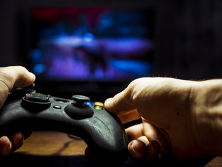 Wall Mural - close up of person holding gamepad and playing games	