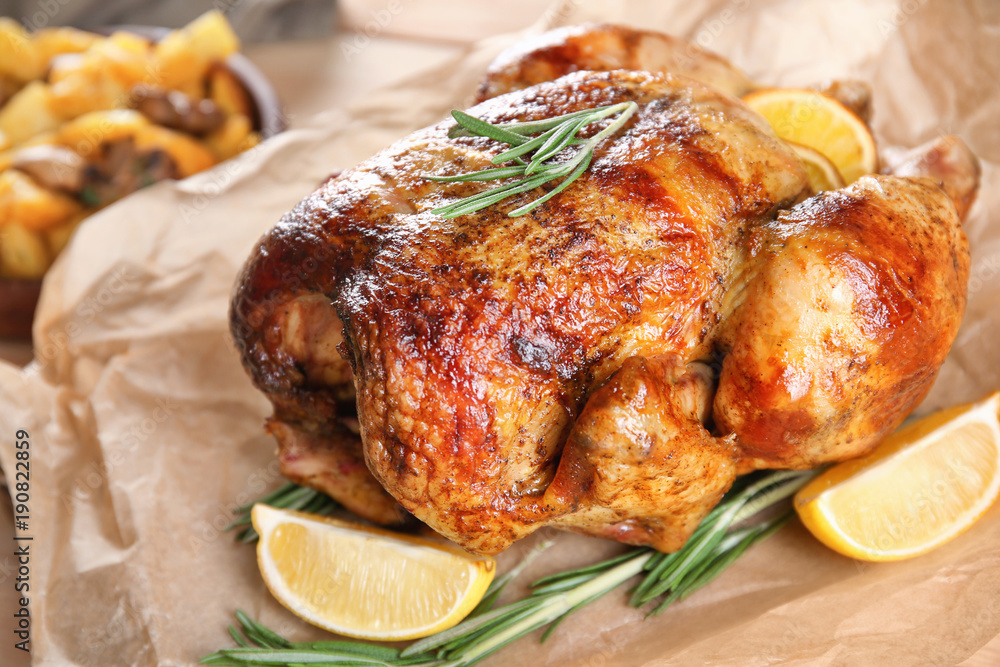 Delicious whole roasted chicken served on table
