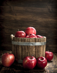 Wall Mural - Red ripe apples in a wooden bucket.