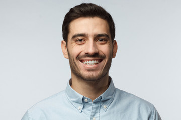 Stylish bearded business man smiling to camera, having pleased expression and cheerful look. Positive emotions concept.