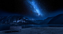 Wooden Bench And Lake Mountain Between At Night With Stars
