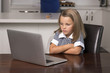 © Wordley Calvo Stock - little girl 6 to 8 years old sitting at home kitchen enjoying with laptop computer concentrated watching internet cartoon movie