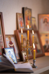 Wall Mural - candle against the background of orthodox icons