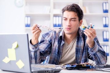 Professional repairman repairing computer in workshop