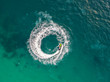 © MAGNIFIER - People are playing a jet ski in the sea.Aerial view. Top view.amazing nature background.The color of the water and beautifully bright. Fresh freedom. Adventure day.clear turquoise at tropical beach.
