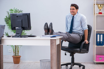 Businessman doing sports in office during break