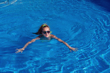 Wall Mural - teen girl relaxing near swimming pool