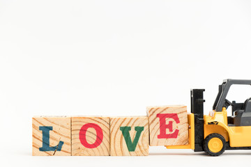 Poster - Toy forklift hold wood letter block E to complete word love on white background