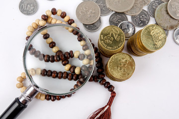 Wall Mural - Rosary and coins. Islamic Banking/Finance concept.